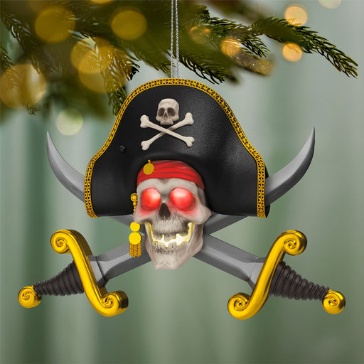 Pirate-themed Christmas ornament with skull, crossbones, and swords on a blurred green background.