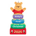 Decorative ornament with Winnie the Pooh for 'Baby's First Christmas 2026' on a white background