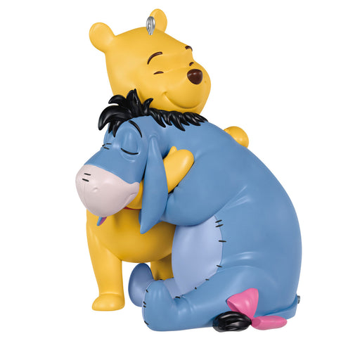 Figurine of a Winnie-the-Pooh and Eeyore hugging on a white background