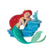 Mermaid figurine with red hair and green tail holding a blue shell on a white background