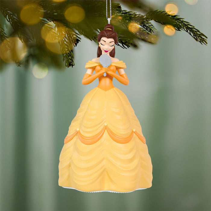 Ornament of a character in a yellow dress against a blurred green background