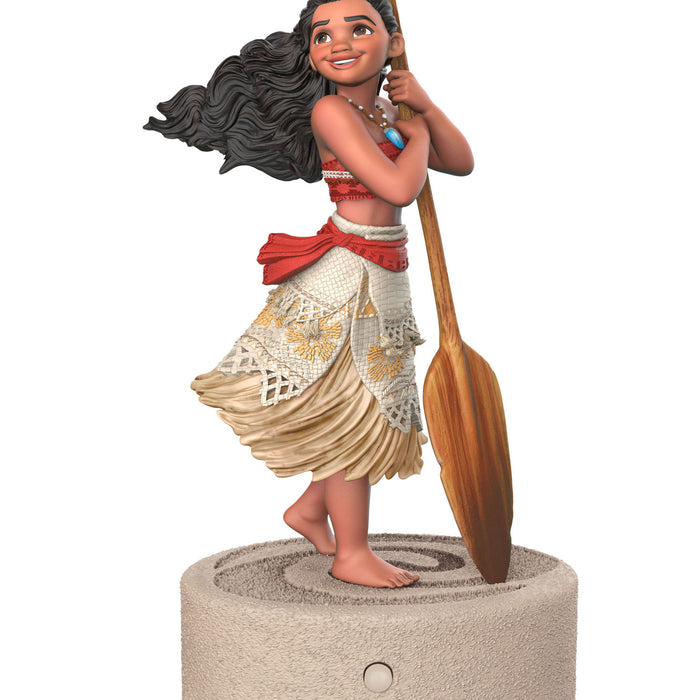 Figurine of a character from Disney's Moana holding a paddle on a white background