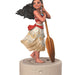 Figurine of a character from Disney's Moana holding a paddle on a white background