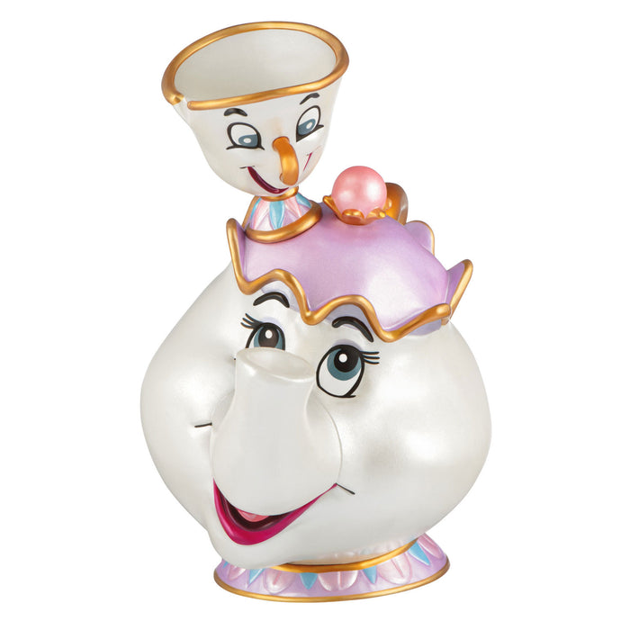 Animated character figurine with a white face, gold accents, and colorful dress on a white background
