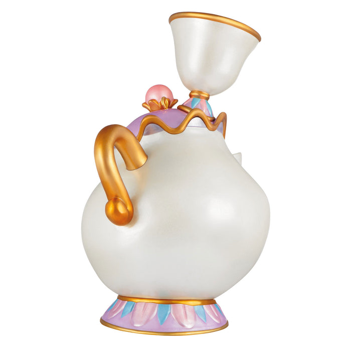 Decorative teapot with gold accents on a white background