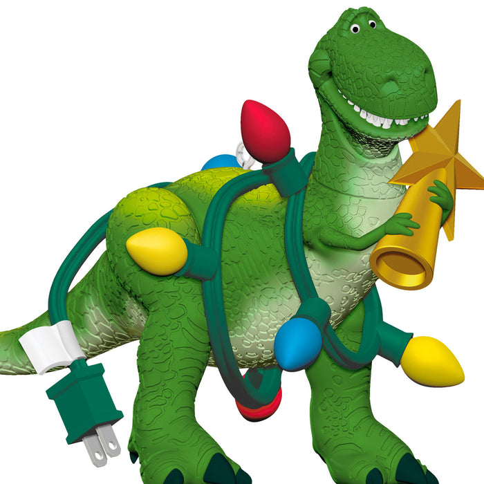 Toy dinosaur with Christmas lights and decorations on a white background
