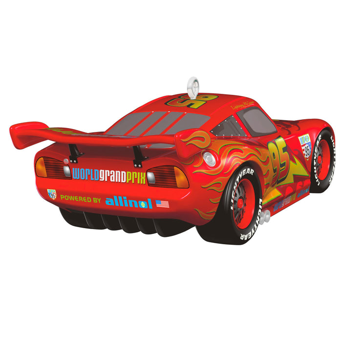 Red toy car with flames and racing decals on a white background