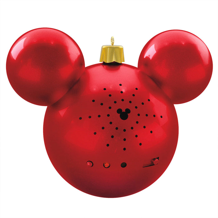 Red ornament shaped like a character with gold top on a white background