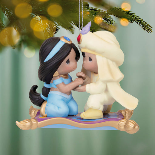 Ornament featuring Aladdin and Jasmine sitting on a magic carpet with a festive background.