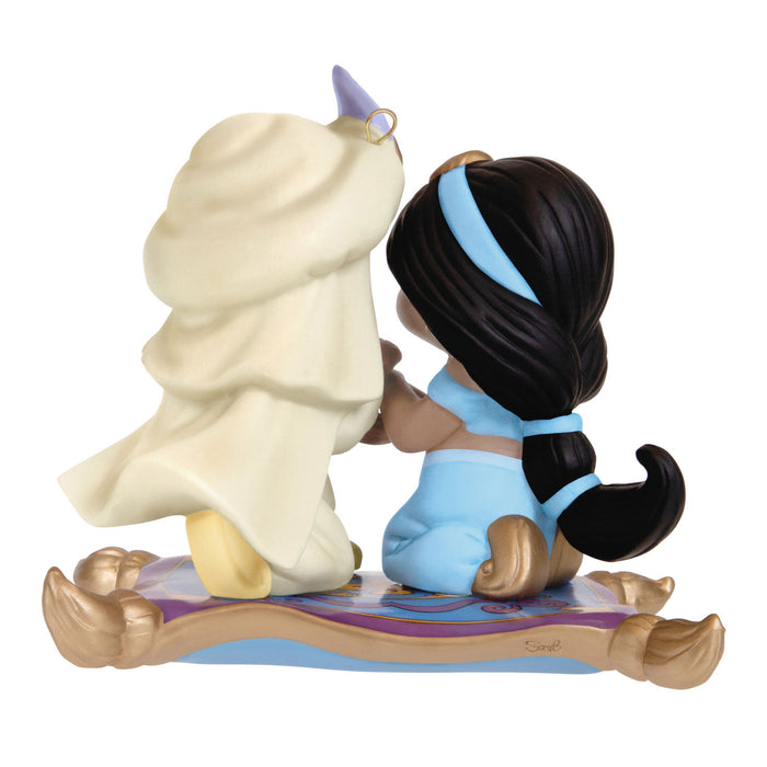 Figurine of a character from Disney's Aladdin with a white creature on a white background