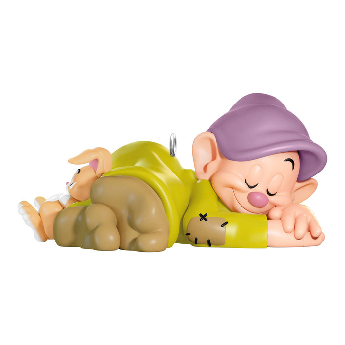 Toy figure of a character with a purple hat and green outfit on a white background