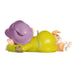 Toy figure of a character in a green outfit with a purple hat, lying on its side.