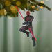 Decorative ornament of a character with red lightsabers hanging from a Christmas tree.