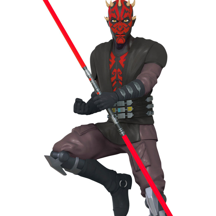 Darth Maul figure from Star Wars with red lightsaber on a white background