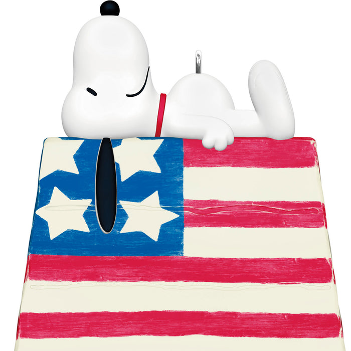 Snoopy figurine on an American flag with a white background