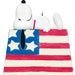 Snoopy figurine on an American flag with a white background