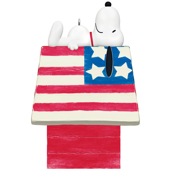 Snoopy sitting on a wooden doghouse with an American flag design on a white background