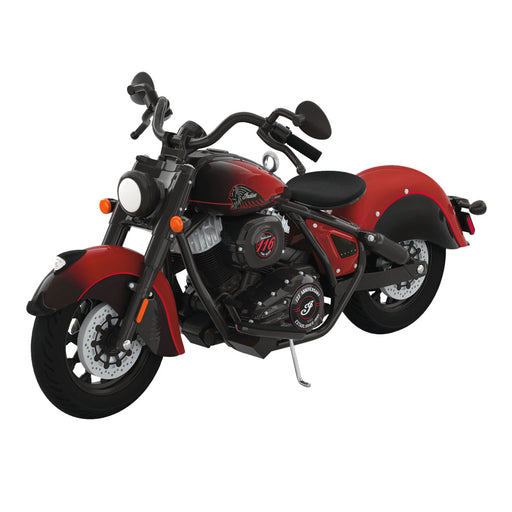 Model motorcycle with red and black design on a white background