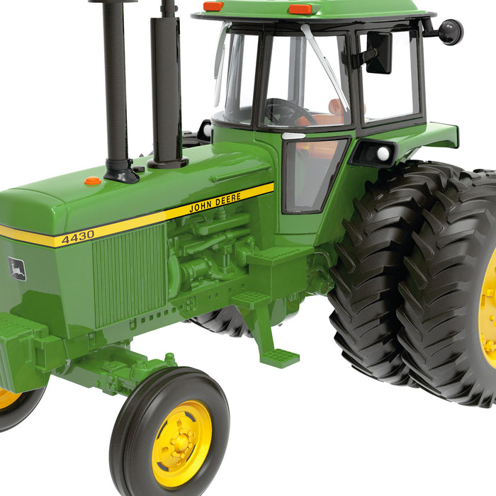 Green John Deere tractor model on a white background