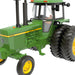 Green John Deere tractor model on a white background