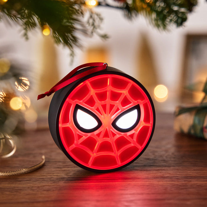 Spider-Man themed round light on a wooden surface with blurred festive background