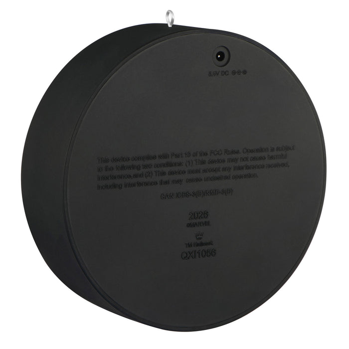 Black circular device with text on a white background