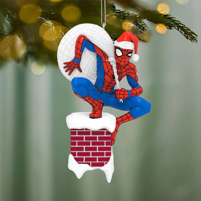 Spider-Man Christmas ornament climbing a chimney with a blurred Christmas tree background
