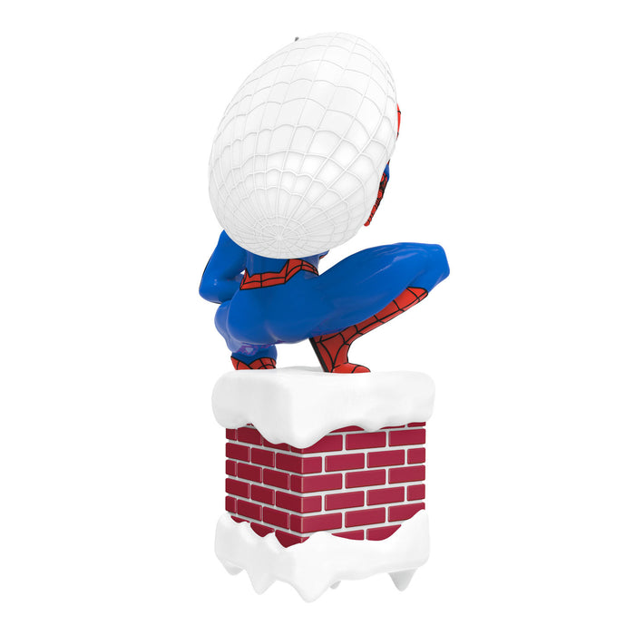 Spider-Man figurine climbing a brick wall with a golf ball on top