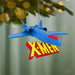 Blue spaceship ornament with X-Men logo hanging on a Christmas tree.