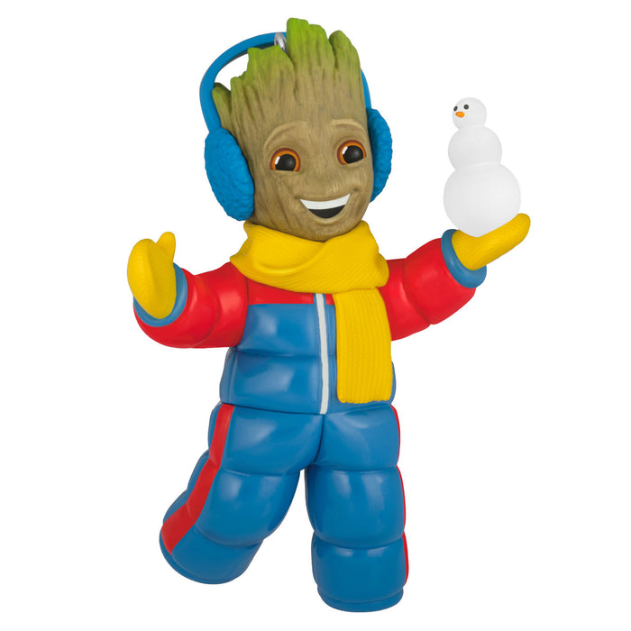 Toy figure of a character in a blue snowsuit with a snowball, on a white background