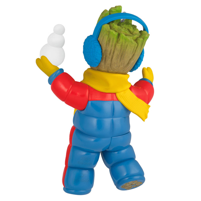 Colorful toy figure with a blue head, red arms, yellow scarf, and blue pants on a white background