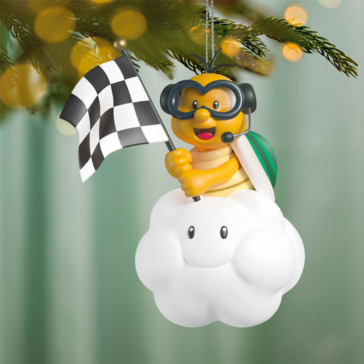 Decorative ornament of a cartoon character on a cloud with a checkered flag, hanging from a tree.