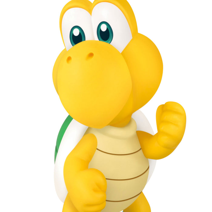 Yellow cartoon turtle character with a white and green shell on a white background