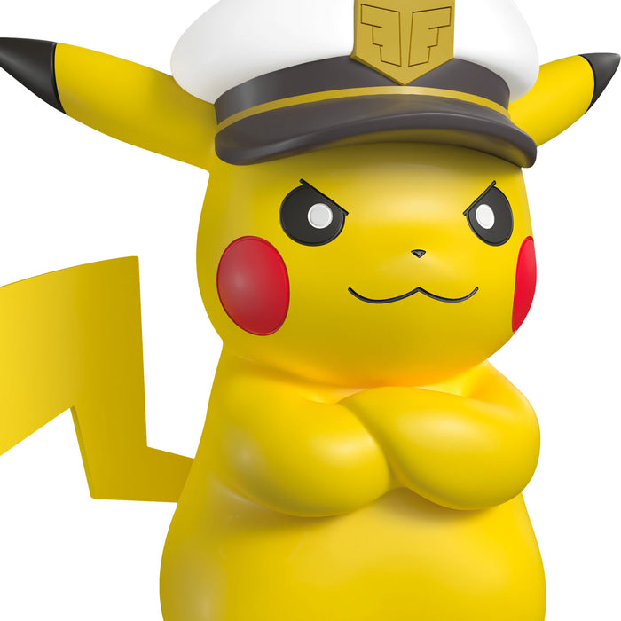Pikachu figurine wearing a captain's hat on a white background