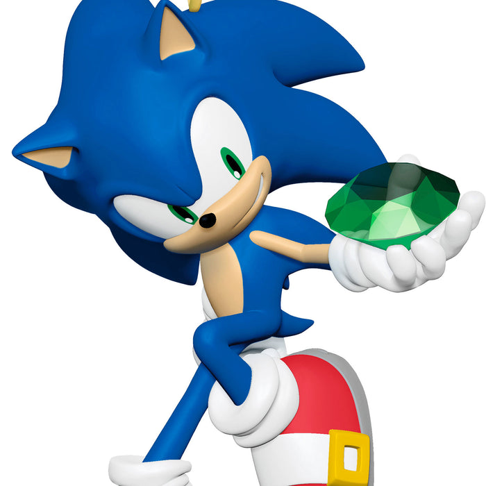 Blue animated character holding a green gem on a white background