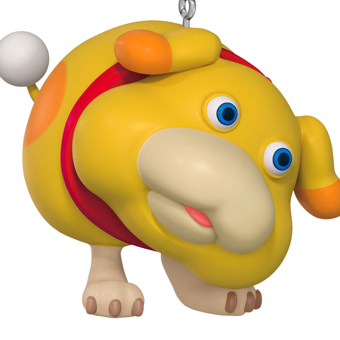 Colorful toy figure of a creature with a round body, blue eyes, and orange accents on a white background.
