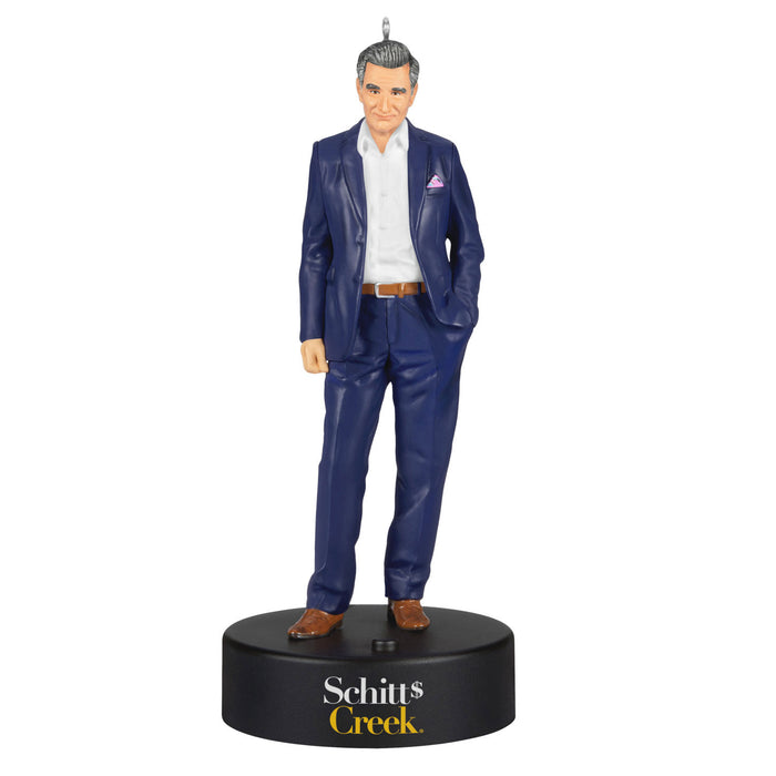 Figurine of a man in a blue suit on a black base with 'Schitt's Creek' branding.