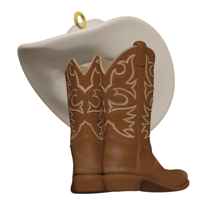 Decorative ornament with cowboy boots and a hat on a white background