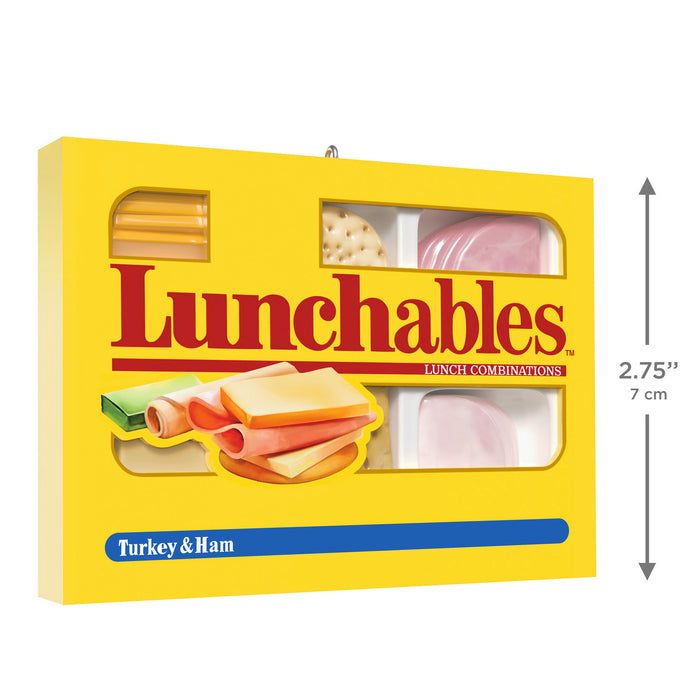 Yellow box of Lunchables with visible layers of food and dimensions on a white background