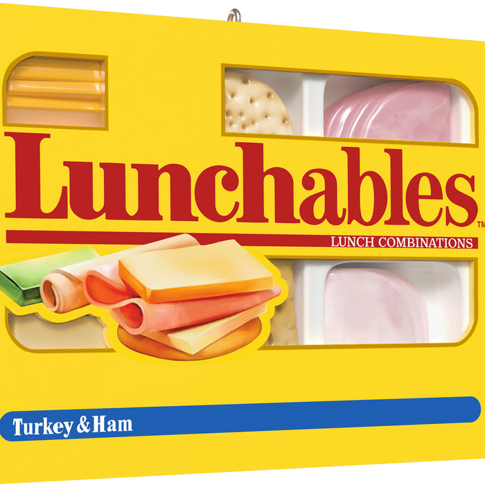 Lunchables packaging with images of turkey and ham slices on a yellow background