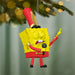 Decorative ornament of a character in a band uniform hanging on a Christmas tree.