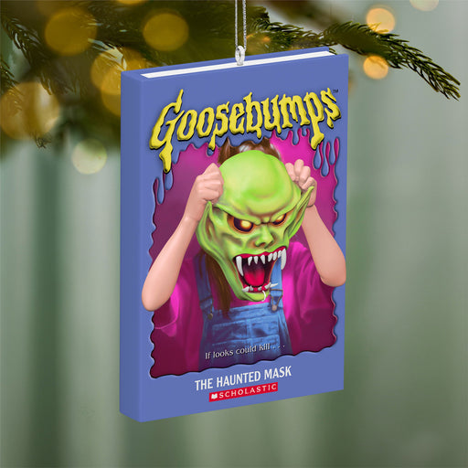 Goosebumps book ornament with a green monster on a blurred Christmas tree background