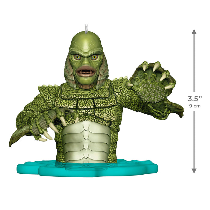 Green creature figurine with measurements on a white background