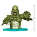 Green creature figurine with measurements on a white background