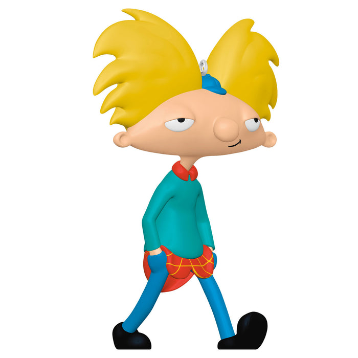 Cartoon character figurine with spiky yellow hair and colorful outfit on a white background