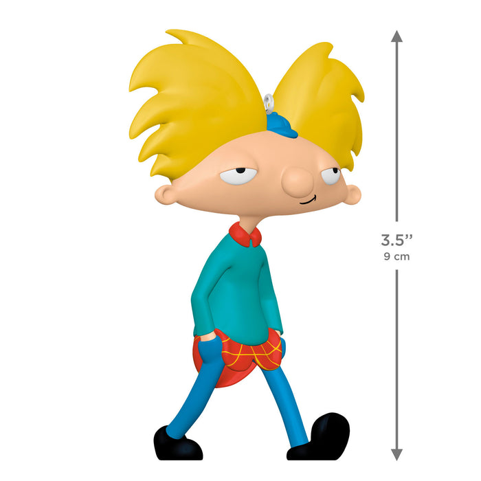 Cartoon character figurine with yellow hair and blue outfit, standing on a white background.