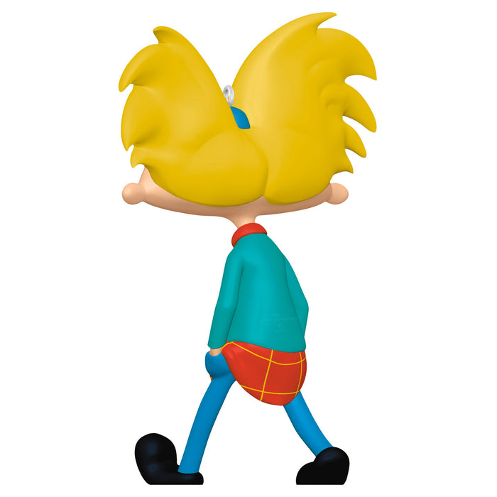 Cartoon character figurine with yellow hair and colorful outfit on a white background