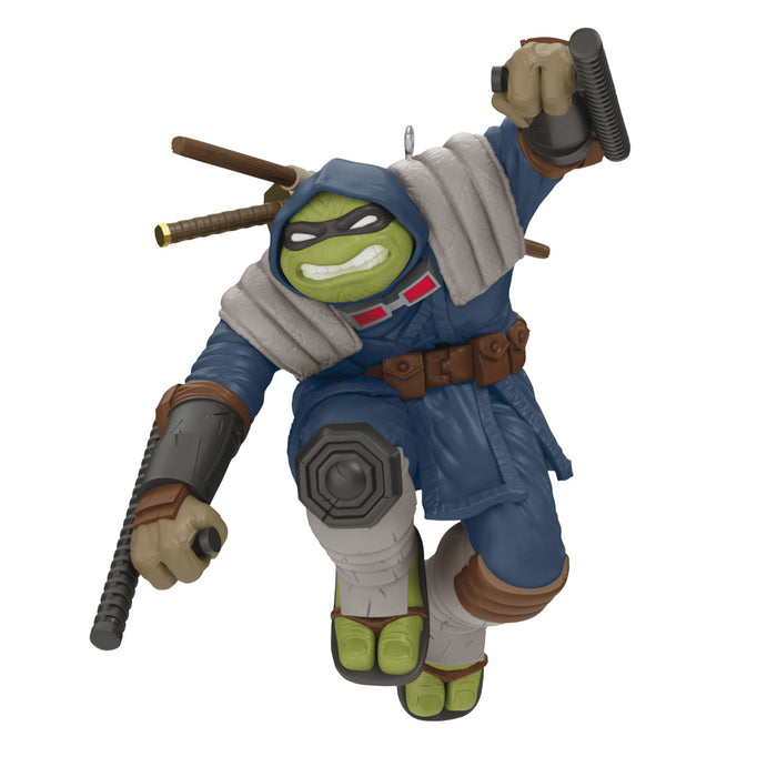 Toy figure of a character in blue outfit with weapons on a white background