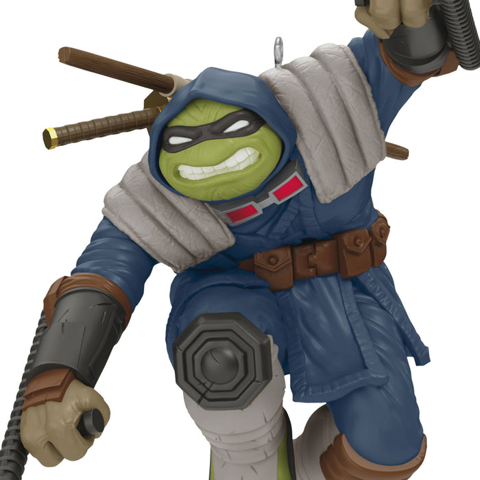 Action figure with a blue outfit and green face, holding weapons on a white background