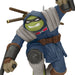 Action figure with a blue outfit and green face, holding weapons on a white background